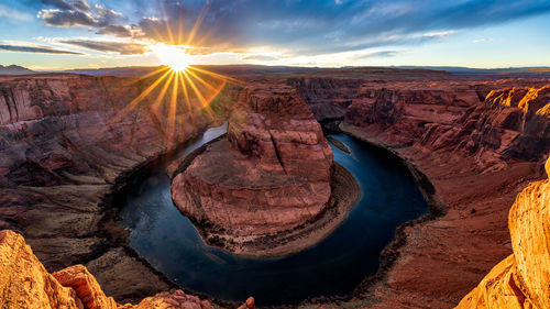 High angle view of horseshoe bend against sky during sunset