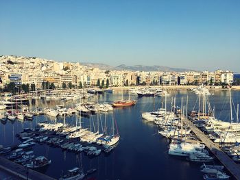 High angle view of marina and buildings against clear sky