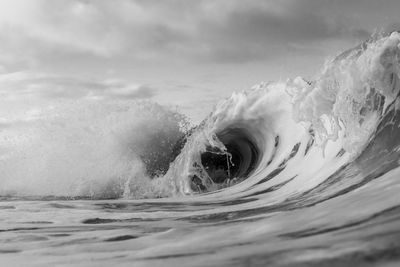 Water splashing in sea against sky