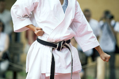 Midsection of woman standing against blurred background