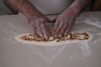 Midsection of man preparing food on table