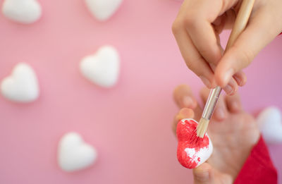 Cropped hand of woman holding a heart shape