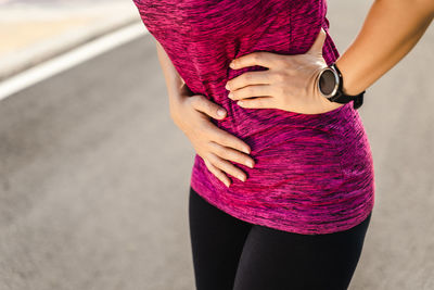 Midsection of woman standing on street