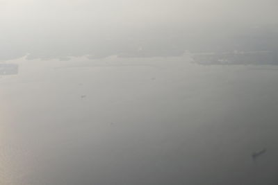 Scenic view of lake against sky during winter