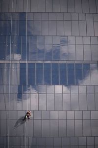 Man working on glass building