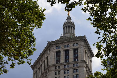 Low angle view of the municipal building against sky in new york city.