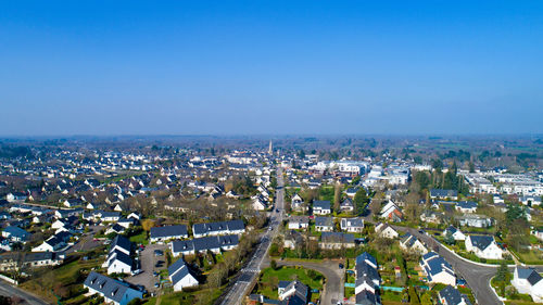 High angle view of cityscape against clear blue sky