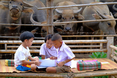 Rear view of people sitting in traditional clothing