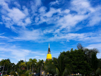 Low angle view of palm trees against blue sky