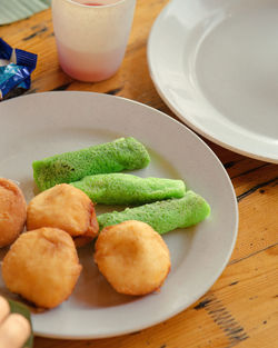 Malaysia sweet dessert with coconut known as kuih ketayap and burger mini.