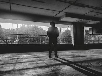 Rear view of silhouette man standing in building