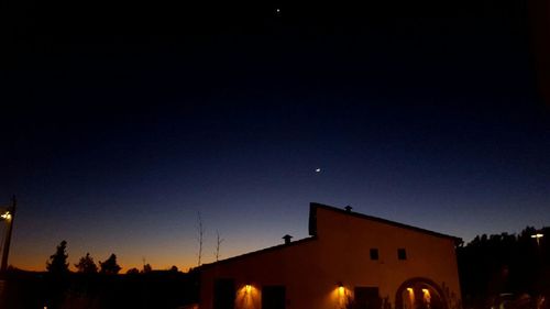 Silhouette built structure against sky at night