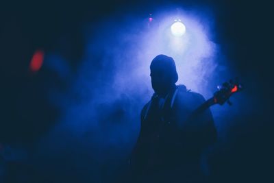 Silhouette musician against backlit