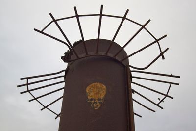 Low angle view of skull art on abandoned pole against clear sky