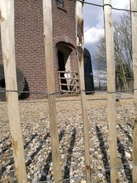 Abandoned building seen through fence