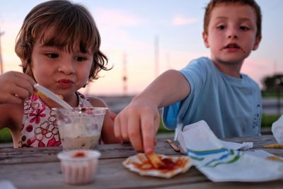 Close-up of children eating outdoors