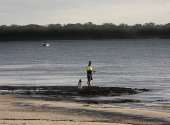 Man standing on beach against sky