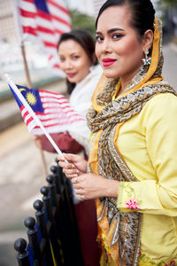 Portrait of smiling young woman standing outdoors