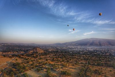 View of hot air balloons flying in city