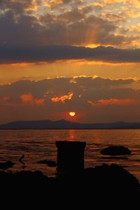 Scenic view of sea against orange sky