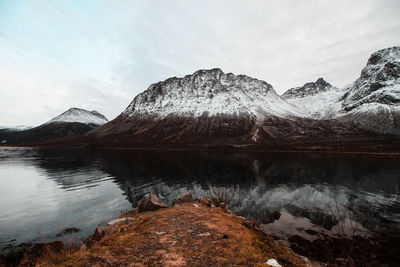 Scenic view of lake and mountains against sky