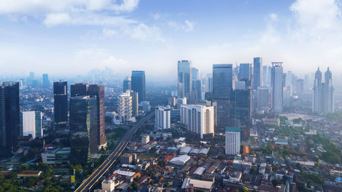 High angle view of modern buildings in city against sky