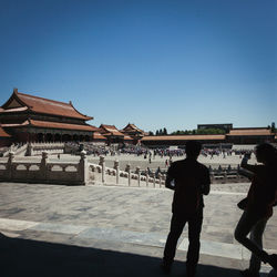 People at forbidden city against clear sky