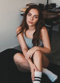 Portrait of a young woman sitting outdoors