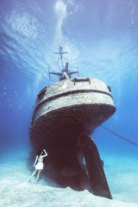 Low angle view of man swimming in sea