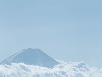 Scenic view of snowcapped mountains against blue sky