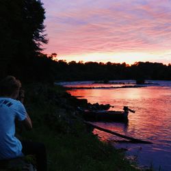 Boats in lake at sunset