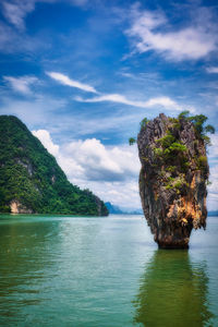 Scenic view of rocks in sea against sky