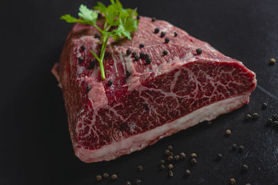 Close-up of cake on table against black background
