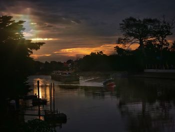 Scenic view of river against sky during sunset