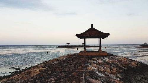 Lifeguard hut on beach against sky