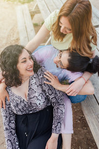 Group of three happy girlfriends embracing and smiling. females enjoy friendship. sorority women.