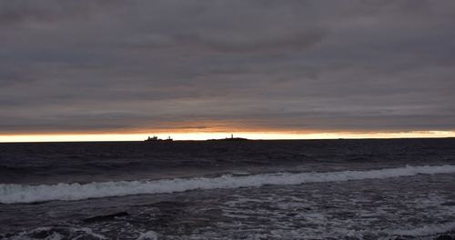 Scenic view of beach against sky during sunset