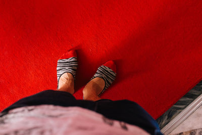 Low section of woman standing carpet 