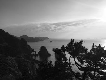 Scenic view of sea and mountains against sky