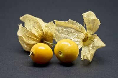 Close-up of fruits on table against black background