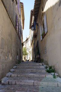 Low angle view of alley amidst buildings