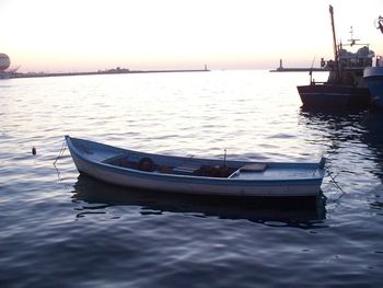 Boat in sea at sunset