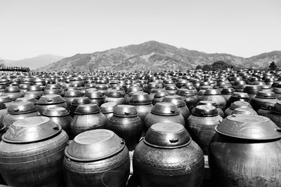 Stack of containers on landscape against sky