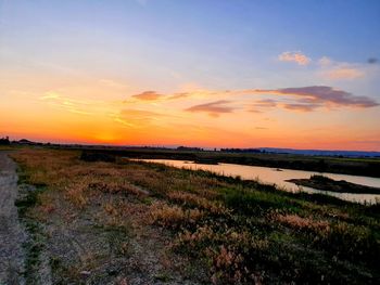 Scenic view of field against sky during sunset