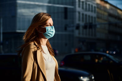 Woman in protective mask at city street