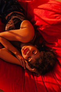 High angle view of man sleeping on bed