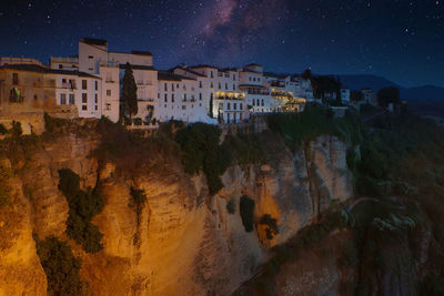 Panoramic view of buildings in city against sky at night