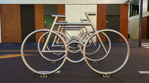 Bicycle rack on footpath against building