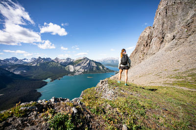 Hiker overlooking upper kananaskis lake during sunset in summer