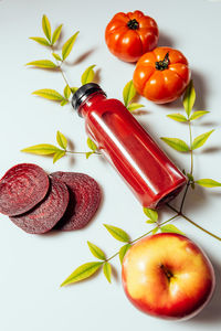 High angle view of tomatoes on table against white background